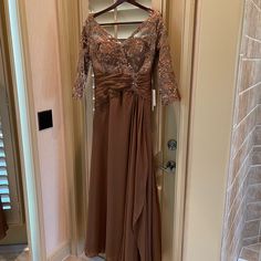 a dress hanging on a hanger in front of a door