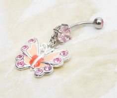 14g surgical steel belly ring with with pink crystal gem and matching pink enameled butterfly charm. Belly ring measures 1 7/8 inches long total length. Barbell is 14g standard surgical steel with a 10mm wearable bar length. Top ball measures 5mm, bottom ball measure 8mm. ** To keep the rhinestones looking their best I do not recommend you wear while swimming or bathing. For Belly Button Rings: https://www.etsy.com/shop/AllAboutClass?section_id=18474235&ref=shopsection_leftnav_1 All body jew Pink Internally Threaded Belly Rings As Gift, Pink Dangle Belly Rings For Gift, Pink Dangle Belly Rings As Gift, Pink Dangle Jewelry With Butterfly Charm, Pink Butterfly Charm Dangle Jewelry, Pink Metal Jewelry With Butterfly Charm, Nickel-free Pink Belly Rings As Gift, Adjustable Nickel-free Pink Belly Rings, Pink Stainless Steel Jewelry With Charms