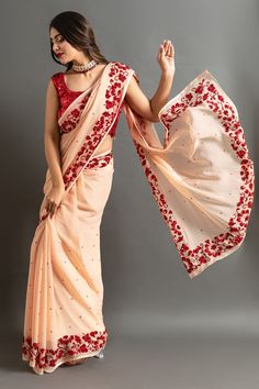 Peach saree highlighted by red sequin embroidered floral motifs on border and sequin buttis. Comes with contrast blouse.
Components: 2
Pattern: Embroidered
Type Of Work: Sequin
Neckline: Round
Sleeve Type: Sleeveless
Fabric: Chiffon
Color: Peach
Other Details: 
Sequin border
Closure: Blouse: Side zip
Occasion: Mehendi and Haldi,Sangeet - Aza Fashions Saree With Contrast Blouse, Peach Saree, Contrast Blouse, Blouse For Women, Red Sequin, Fashion App, Blouse Online, Floral Motifs, Sarees Online