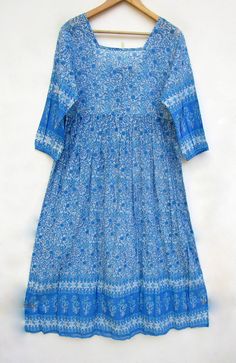 "ITEM DESCRIPTION summer blue flower printed cotton long maxi dress - square neckline with back tassel maxi dress - 3/4th sleeve maxi dress Features: 3/4th sleeve, square neck, Long dress Material: Cotton Voile Fabric: 100% cotton soft light weight ethnic print fabrics  Sleeve Length = 18 inch For more sizes & their measurement, please refer our below chart to understand the sizes variations available with us For your size requirement, please mention your size in seller note at the time of buyin Blue Half-sleeve Maxi Dress For Vacation, Blue Cotton Maxi Dress With 3/4 Sleeves, Long Blue Floral Print Boho Dress, Blue 3/4 Sleeve Maxi Dress For Beach, Blue Long Boho Print Dress, Bohemian Blue 3/4 Sleeve Dress, Long Blue Boho Print Dress, Blue Long Boho Dress With Floral Print, Long Blue Boho Dress With Floral Print