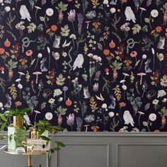 the wallpaper in this room is painted with flowers and birds on it, along with plants