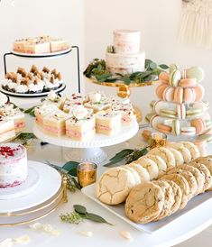 a table topped with lots of different types of cakes and desserts next to each other