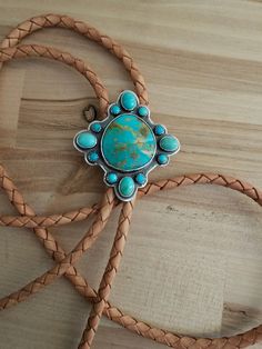 I have used 925 sterling silver for this amazing piece.  I have chosen some amazing genuine turquoise.  The focal stone is a natural Royston.  And I have surrounded it with Campitos and Kingman turquoise.  I have shaped this for a unique appeal.  Then added patina to excentuate the gorgeous colors.  I have chosen a beautiful natural color for the leather.   And added a tension bolo clasp for ease of adjustment. And prevent damage to the gorgeous genuine leather.  The ends are my creation for tha Western Style Turquoise Gemstone Jewelry, Sterling Silver Turquoise Concho Jewelry, Blue Turquoise Concho Necklace As A Gift, Rustic Turquoise Concho Jewelry, Adjustable Western Style Gemstone Jewelry, Bohemian Turquoise Jewelry With Concho, Bohemian Turquoise Concho Jewelry, Adjustable Southwestern Turquoise Ring With Natural Stones, Artisan Turquoise Concho Necklace Gift