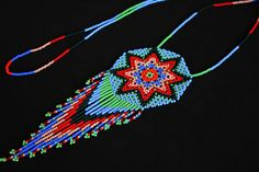 "Size\" Approx. length - 20\" Approx. diameter of medallion - 2.25\" Item Description: - A beautiful traditionally beaded Southwestern Native American/Huichol medallion necklace. - This piece is made using a freehand beading technique - The thread used is synthetic and very strong. - For use anywhere. Sophisticated enough formal occasions and fun enough for casual time. More Info: - All packages ship through Canada Post. Their service is secure, consistent and reliable. Passing customs, your nat Necklace Traditional, Beaded Star, Festival Necklace, Car Shoe, Teddy Dog, Sun Necklace, Beading Techniques, Cell Phone Covers, Medallion Necklace