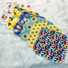 four bandana bibs laying on top of a white furnishing covered floor