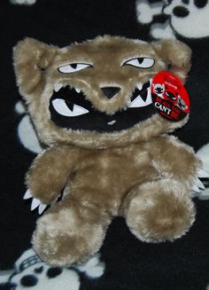 a teddy bear with fake teeth and fangs on it