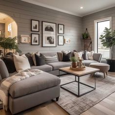 a living room filled with furniture and pictures on the wall