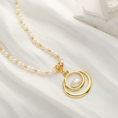 Adorn your neck with the remarkable elegance of our Oval Pearl Necklace. Crafted with 18k gold, this luxurious accessory will complete any ensemble with its timeless sophistication. With its alluring classic design, its sure to make a statement of timeless style. DETAILS Plating: 18K Gold Materials: 18K Gold on Brass, Freshwater Pearl Measurements: Length: 16.54"(42.0cm) + Extender: 2.36"(6.0cm) Weight:  36.59 g Elegant Oval Necklace With Pearl Charm, Gold Necklace With Pearl Chain And Oval Pendant, Gold Refined Pearl Necklace, Gold Oval Necklace With Elegant Design, Refined Gold Pearl Necklace, Oval Gold Necklace With Elegant Design, Oval Gold Pearl Necklaces, Elegant Pearl Drop Necklace With Oval Pendant, Elegant Oval Pendant Pearl Drop Necklace