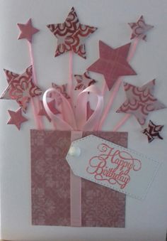 a birthday card with pink and silver stars