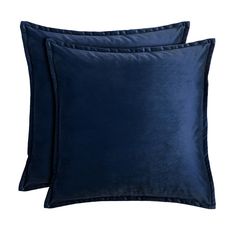 two navy blue velvet pillows on a white background, one is square and the other is rectangular