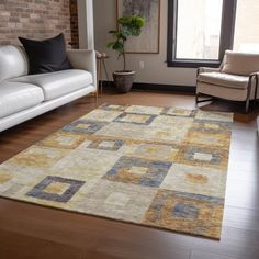 a living room filled with furniture and a large rug on top of a hard wood floor