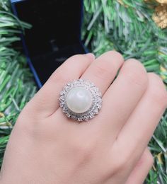 White Sea Pearl Halo Elegant Vintage Ring Pearl jewelry Stylish Ring Gift jewelry Imitation Pearl Ring jewelry Adjustable size 6-8 Exaggerated jewelry Special and unique jewelry ♥ Ready to ship ♥ The main stone is the Finest Imitation Pearl. ♥ Absolutely gorgeous and beautifully handcrafted Finest Imitation Pearl in an exquisite setting. ♥ This classic yet trendy Jewelry makes the perfect Christmas/Anniversary/Valentine's/Birthday gift for her that will be treasured forever. We have confidence t Luxury Elegant Pearl Ring With Halo Design, Luxury White Pearl Ring With Halo, Luxury Halo Pearl Ring For Anniversary, Luxury Pearl Ring With Halo Design, Exquisite Round Halo Ring Gift, Exquisite Halo Ring With Round Shape For Gift, Pearl Promise Ring With Halo Setting, Elegant Silver Opal Ring With Cubic Zirconia, Diamond White Pearl Promise Ring