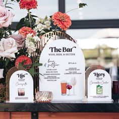 the bar is set up with flowers and wine glasses for guests to take their place