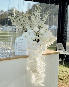 white flowers and wine glasses on display at an event