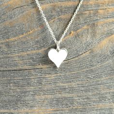 "Beautiful cut sterling silver heart charm necklace with your choice of chain- sterling silver 925 chain in 16\" or 18\" lengths. The dainty heart charm pendant measures 13.4mm x 9.8mm. ♥ New Ready to Ship section-orders will ship out within 1-2 days. This necklace will arrive in a box tied with a ribbon perfect for gift giving. Also, included will be a polish pad, anti-tarnish bag with an anti-tarnish tab for storing. Please read my policies before placing an order. Convo me if you have any que Hand Stamped Double Heart Sterling Silver Jewelry, Simple Silver Heart Necklace For Valentine's Day, Everyday Hand Stamped Heart Pendant Jewelry, Dainty Hand Stamped Heart Necklaces, Hand Stamped Heart Sterling Silver Charm Necklace, Dainty Hand Stamped Heart Charm Necklace, Dainty Heart-shaped Hand Stamped Charm Necklace, Sterling Silver Hand Stamped Heart Charm Necklace, Everyday Heart Shaped Nickel Free Necklace