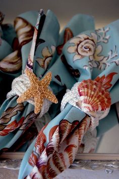 two hair bows with seashells and starfish on them are sitting on a table