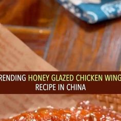 a close up of a piece of food on a table with the words reading honey glazed chicken wings recipe in china