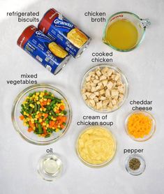 ingredients to make chicken soup laid out on a white surface with labels labeled in the top left corner