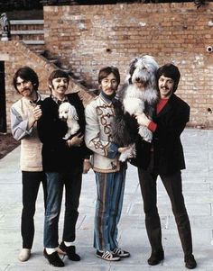 the beatles posing for a photo with their dog