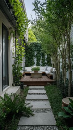 an outdoor seating area in the middle of a garden with steps leading up to it