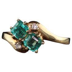 Beautiful Vintage Retro 14K Yellow Gold Colombian Emerald Toi et Moi Diamond Ring. This gorgeous ring is crafted in 14k yellow gold. The ring has two beautiful colombian emeralds on it with single cut diamonds above and below. The ring is i great condition and sits low on the finger. Item #R1544 Metal: 14K Yellow Gold Weight: 2.4 Grams Size: 5 3/4 Diamonds: Approximately .05 cts Color: H Clarity: SI1 Emeralds: Approximately .60 cts Measurements: Top of the ring measures 8.82 mm wide and band mea