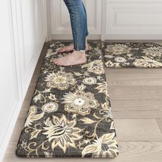 a person standing on top of two rugs