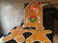 two gingerbread cut outs sitting on top of a stove