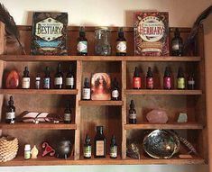 an old wooden shelf filled with bottles and other items