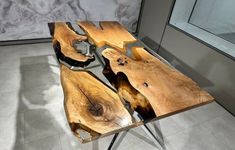 a table made out of wood with metal legs and two pieces of wood on top