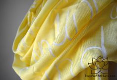 a yellow fabric with white letters on it