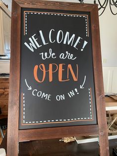 a sign that says, welcome we are open come on in