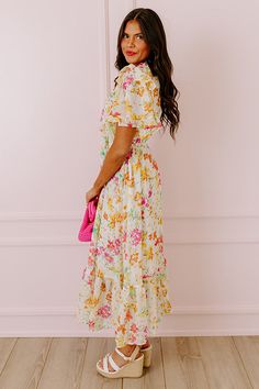 - Drape yourself in petals and twirl in the sun with this airy dress! - Chiffon material with a colorful abstract floral print - A built-in lining that ends above the ruffled hemline - A ruffled v-cut neckline with a tie detail - Short, loose ruffled sleeves - Pleated detail at the bodice - An elastic waistline - A flowy yet flattering silhouette that ends in a ruffled maxi length hemline Floral Print Flowy Dress For Brunch, Breezy Ruffled Dresses For Garden Party, Vacation Midi Dress With Ruffle Hem And Flowy Skirt, Breezy Floral Print Midi Dress For Garden Party, Multicolor Ruffle Hem Maxi Dress For Spring, Spring Multicolor Maxi Dress With Ruffle Hem, Flowy Vacation Dress With Ruffle Hem, Chiffon Midi Dress With Floral Print For Beach, Summer Chiffon Floral Dress In Tiered Style