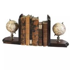 an old fashioned bookend with two globes on top of it and three books