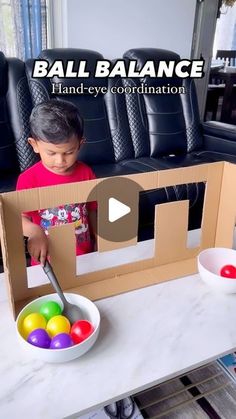 a little boy standing in front of a cardboard box with an easter egg inside it