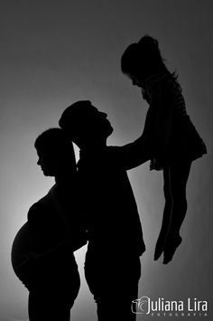 a black and white photo of a man holding a child