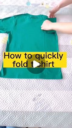 someone is holding onto a t - shirt with the words how to quickly fold it