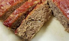 sliced meatloaf with ketchup on top and another piece cut in half