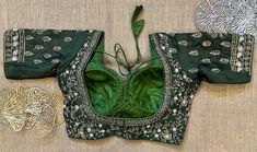 Stunning dark green heavy embroidery designer blouse. Buy designer blouse in USA from Pure Elegance. Disclaimer: The actual product may vary slightly from the image. These are custom orders, hence expect slight variation in color, placement of the motif or buta. ESTIMATED DELIVERYBecause this is a custom order, it would take about 4 weeks from the date of purchase. RETURN POLICY: This product is a custom order and cannot be returned or exchanged. Fitted Green Choli With Floral Embroidery, Designer Green Traditional Wear With Resham Embroidery, Elegant Green Blouse With Floral Embroidery, Festive Green Embroidered Fitted Top, Festive Green Embroidered Floral Top, Festive Fitted Green Embroidered Top, Festive Green Floral Embroidered Top, Green Intricately Embroidered Festive Top, Green Embroidered Top For Festive Occasions