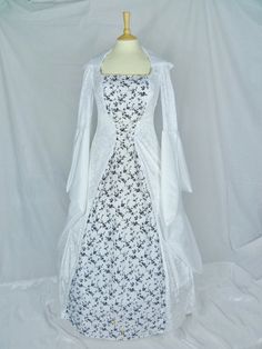 This dress will be made to the measurements you send me.Please send me your bust,waist and hip measurements and please measure from the top of your shoulder to the floor with shoes on.It will be made with beautiful white velvet and stunning white and black flock taffeta fabric. The sleeves are part white velvet and taffeta. It has a corset style front and back will lacing so you can adjust the dress to fit your body shape.Combined shipping on multiple items.If you purchase express shipping by co White Fitted Ball Gown Dress, Lace Corset Dress For Wedding, White Fitted Ball Gown Corset Dress, Wedding Corset Dress With Lined Bodice, Ball Gown Shape, Wedding Ball Gown Corset Dress With Lined Bodice, Fitted White Corset Ball Gown Dress, Wedding Corset Dress With Sweetheart Neckline And Sweep Train, Wedding Corset Dress With Sweep Train And Fitted Bodice, White Fitted Ball Gown For Bridesmaid