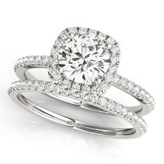 an engagement ring set with a round diamond center surrounded by two rows of pave diamonds