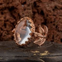 Dur E Najaf Flower Rose Gold Plated Silver Women Ring. Handmade in 925 rose gold color plated sterling silver with Dur E Najaf stone. On the ring Oval Najaf stone settled. At sides, flower figure settled with micro detailed ornament. Dimensions of stone is 20 mm x 15 mm. Average weight of Dur E Najaf Flower Rose Gold Plated Silver Women Ring is 9 gr. (depends on your ring size). Back side is open and stone touches your skin. Classic and exclusive style. Stone Type: Dur E Najaf Stone Color: Clear Unique Oval Rose Gold Jewelry, Unique Rose Gold Oval Jewelry, Unique Rose Gold Jewelry For Jewelry Making, Unique Hallmarked Rose Gold Jewelry, Rose Gold Nature-inspired Jewelry For Anniversary, Nature-inspired Rose Gold Ring Jewelry, Nature-inspired Rose Gold Gemstone Jewelry, Dur E Najaf Ring, Silver Handmade Jewelry