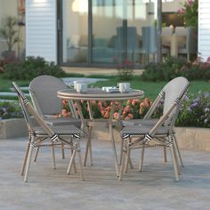 three chairs and a table on a patio