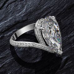 This stunning ring replicates a $14,500 look with a 3 carat pear cut flawless center stone, and round cut side stones. This amazing timeless ring is a perfect addition for your collection and serves well as an engagement ring as well. This beautiful ring gives you the same look of white gold and diamonds at a fraction of the cost. The stones are flawless moissonite, which sparkle with incredible fire and brilliance. They are all individually hand set by experienced master jewelers. The ring is m Modern Ring Design, Pear Cut Engagement Ring, Favorite Engagement Rings, Pear Cut Engagement Rings, Timeless Ring, Rings Jewelry Fashion, Modern Ring, White Gold Jewelry, Engagement Ring Styles