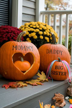 two pumpkins with the words mommy and big sister carved into them sitting on a porch