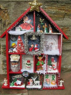 a red and white doll house with christmas decorations