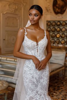 a woman in a wedding dress posing for the camera