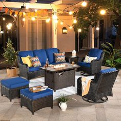 an outdoor patio with blue furniture and lights