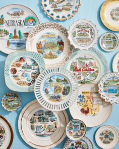 many plates are arranged on a blue wall