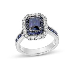 a blue and white diamond ring with diamonds on it's sides, set in 18k white gold