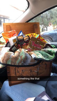 a basket filled with food sitting in the back seat of a car